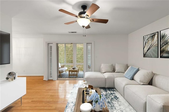 living room with ceiling fan and hardwood / wood-style floors