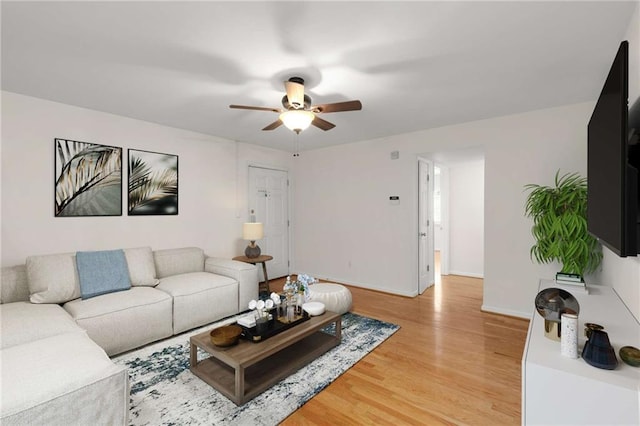 living room featuring ceiling fan and hardwood / wood-style floors