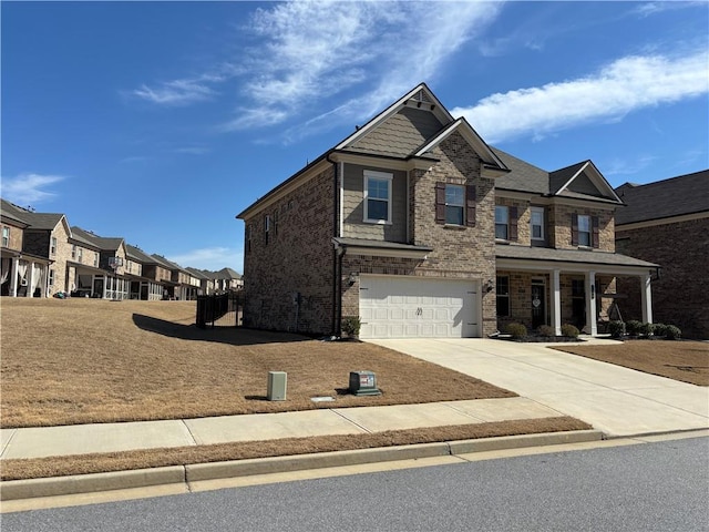 3566 Andover Way, Buford, GA 30519 - view of front of property featuring concrete driveway, brick siding, a garage, covered porch, and a residential view