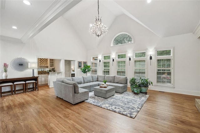 119 Kennemer Ct, Duluth, GA 30097 - living room with high vaulted ceiling, light wood-style flooring, a chandelier, recessed lighting, and crown molding