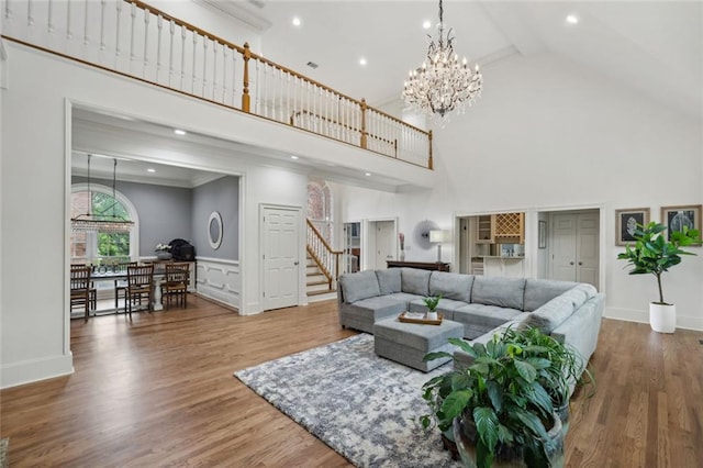 119 Kennemer Ct, Duluth, GA 30097 - living area with high vaulted ceiling, stairs, a chandelier, beam ceiling, and wood finished floors