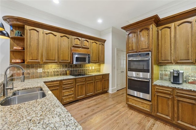 119 Kennemer Ct, Duluth, GA 30097 - kitchen with a sink, stainless steel appliances, ornamental molding, backsplash, and light stone countertops