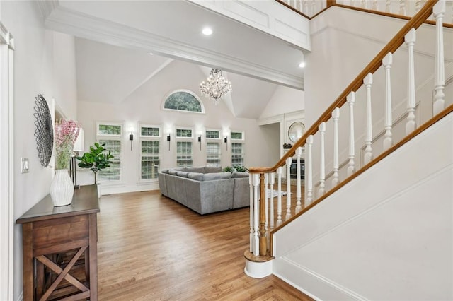 119 Kennemer Ct, Duluth, GA 30097 - foyer entrance featuring high vaulted ceiling, stairs, wood finished floors, and a chandelier