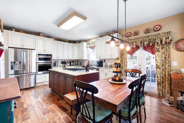 kitchen featuring light countertops, wood finished floors, french doors, and stainless steel appliances