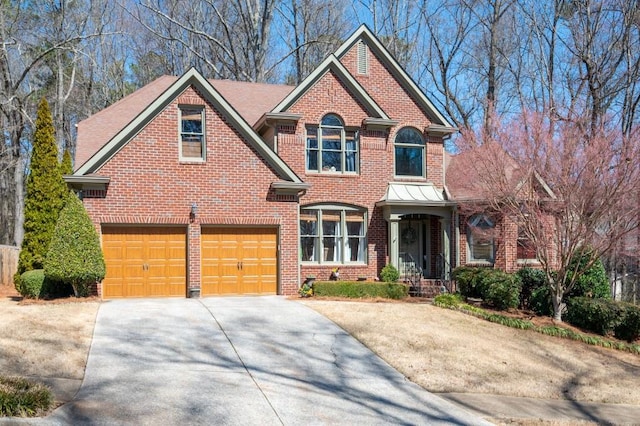 view of front of house featuring a garage, brick siding, and concrete driveway