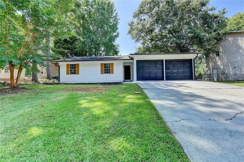 2508 Wagon Trce, Duluth, GA 30096 - ranch-style house featuring an attached garage, concrete driveway, and a front lawn