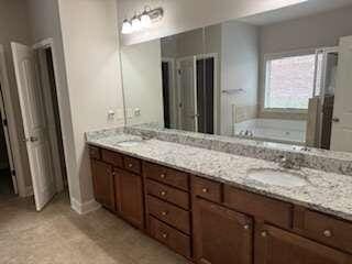 bathroom featuring vanity and a tub