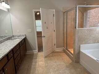 bathroom with independent shower and bath and vanity