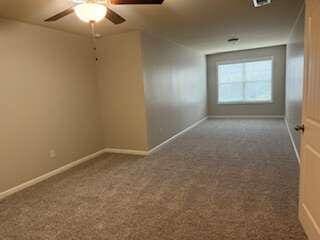 empty room with carpet flooring and ceiling fan