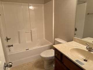 full bathroom with toilet, bathtub / shower combination, and vanity