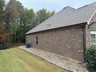 view of property exterior featuring a lawn