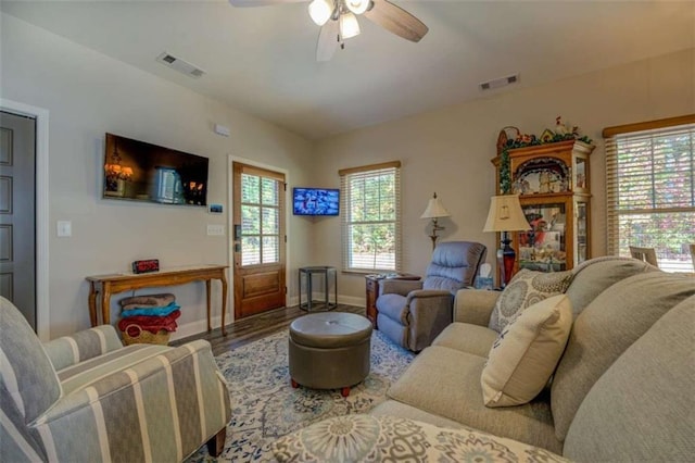 living room featuring wood-type flooring and ceiling fan