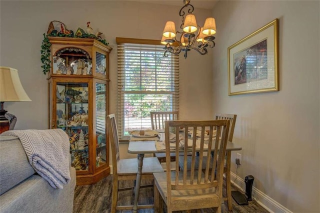 dining area with an inviting chandelier and dark hardwood / wood-style flooring