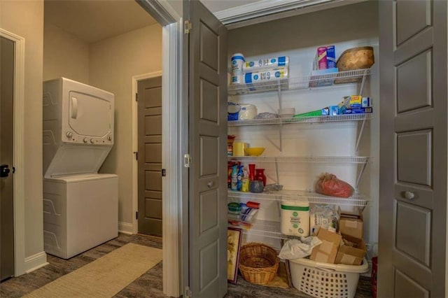 pantry featuring stacked washing maching and dryer