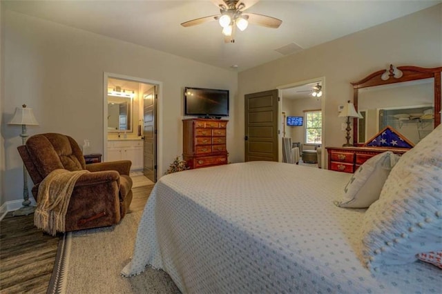 bedroom with ceiling fan, hardwood / wood-style floors, and ensuite bathroom