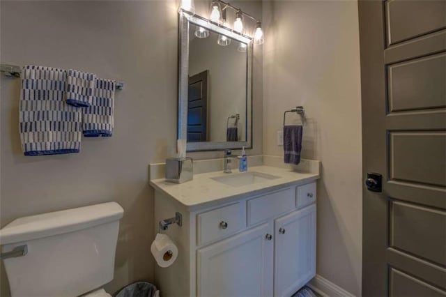 bathroom featuring toilet and vanity