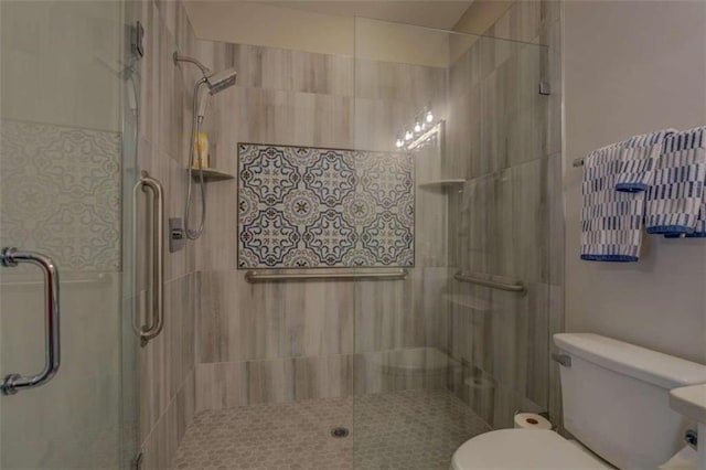 bathroom featuring toilet and walk in shower