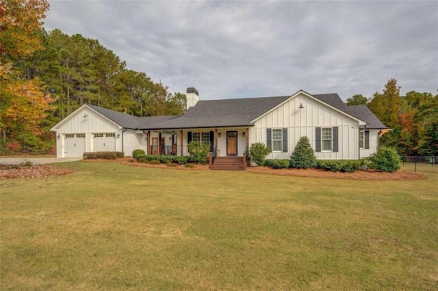 ranch-style home featuring a garage, a front yard, and a porch