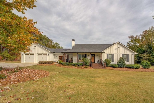 ranch-style house featuring a porch, a garage, and a front lawn