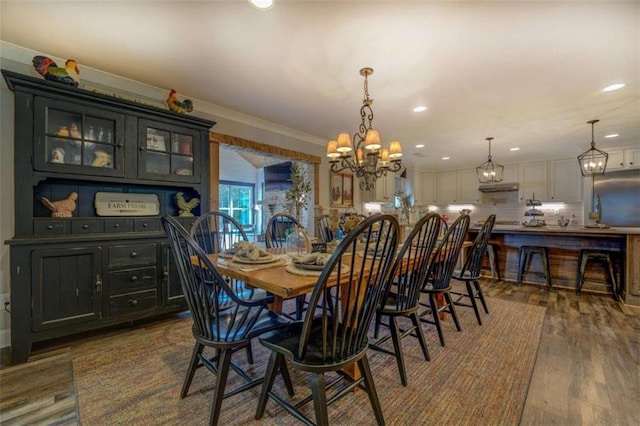 dining room with dark wood-type flooring and ornamental molding