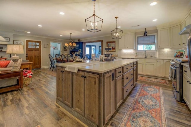 kitchen featuring hanging light fixtures, stainless steel electric range oven, white cabinetry, dark hardwood / wood-style floors, and a kitchen island