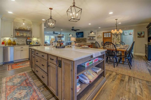 kitchen with a kitchen island, white cabinets, and pendant lighting