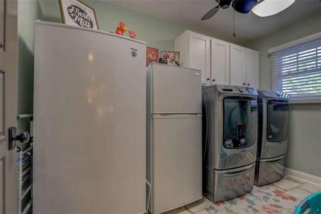 clothes washing area with ceiling fan, cabinets, washer and clothes dryer, and light tile patterned flooring