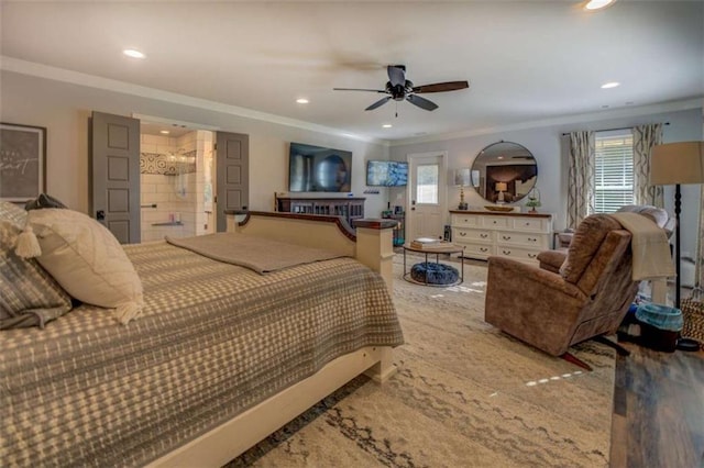 bedroom featuring ceiling fan, ensuite bath, and crown molding