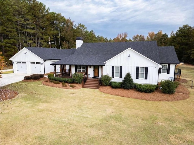 view of front facade with a garage, a front yard, and a porch