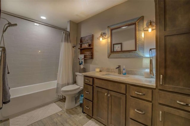 full bathroom featuring toilet, shower / bath combination with curtain, and vanity