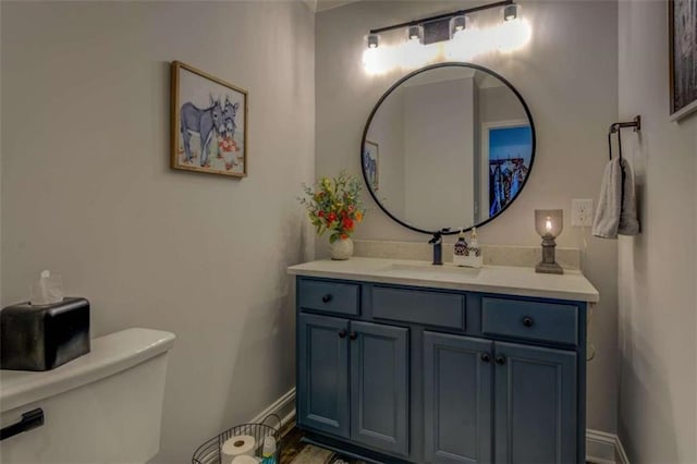 bathroom featuring toilet and vanity