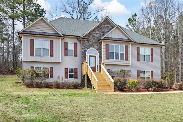 view of front of home with a standing seam roof, stone siding, a shingled roof, and a front lawn