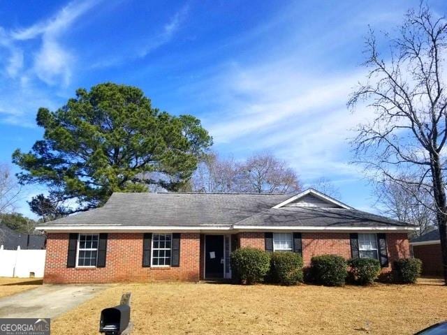 ranch-style house with brick siding and fence