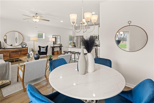 204 Epping St Unit 2, Stockbridge, GA 30281 - dining area featuring recessed lighting, light wood-style flooring, baseboards, and ceiling fan with notable chandelier