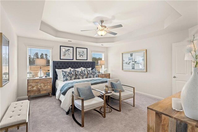 204 Epping St Unit 2, Stockbridge, GA 30281 - bedroom with baseboards, a tray ceiling, a ceiling fan, and light carpet