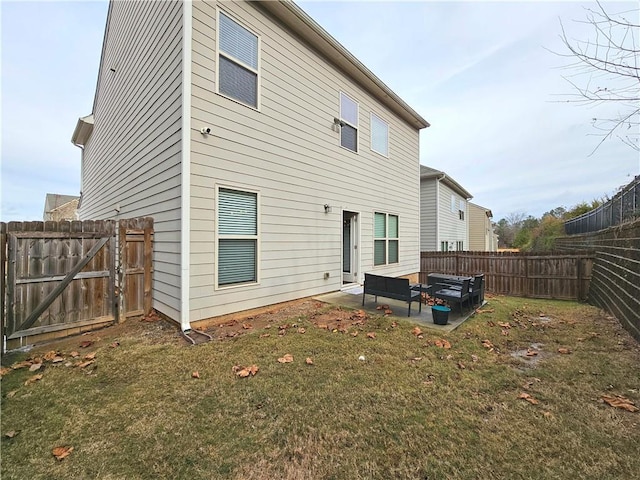 back of property with a yard and a patio