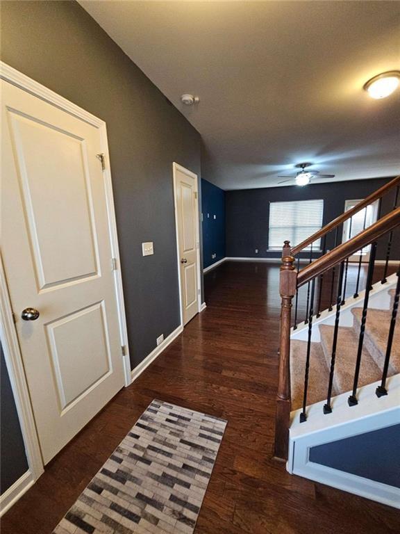 corridor with dark hardwood / wood-style floors