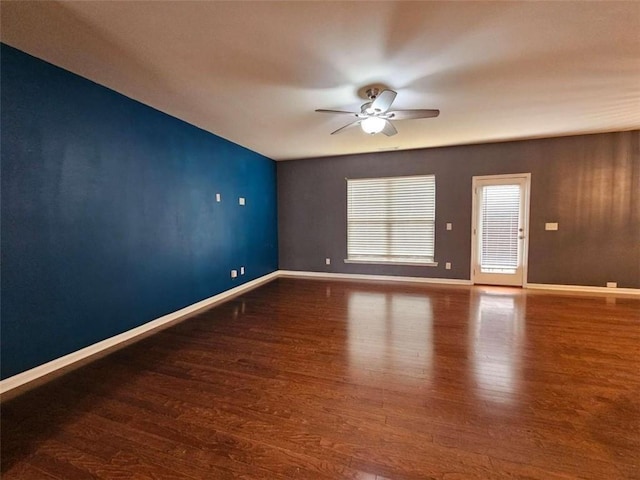 unfurnished room with dark wood-type flooring and ceiling fan