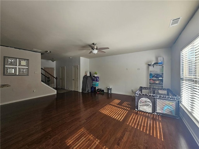 interior space featuring ceiling fan and dark hardwood / wood-style floors