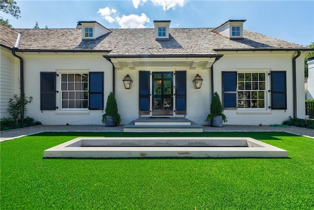 back of property with a yard and french doors