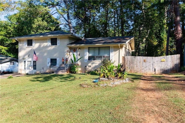 split level home with a front lawn