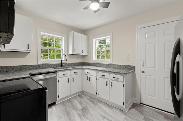 1098 Cascade Cir SW, Atlanta, GA 30311 - kitchen with a sink, electric range oven, stainless steel dishwasher, ceiling fan, and white cabinets