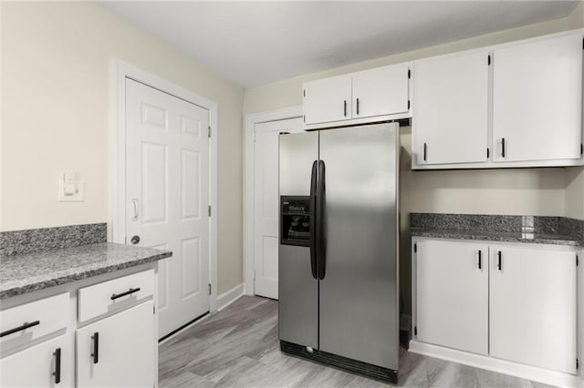 1098 Cascade Cir SW, Atlanta, GA 30311 - kitchen featuring stainless steel refrigerator with ice dispenser, white cabinetry, dark stone counters, and baseboards