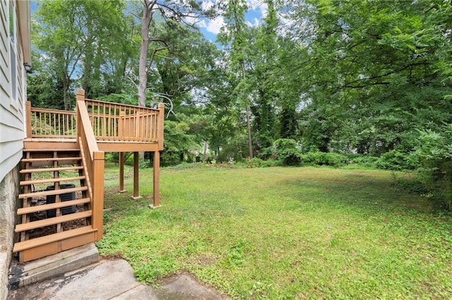 1098 Cascade Cir SW, Atlanta, GA 30311 - view of grassy yard with stairway, a deck, and view of wooded area