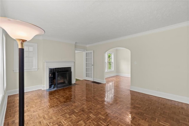 1098 Cascade Cir SW, Atlanta, GA 30311 - unfurnished living room featuring baseboards, a textured ceiling, a fireplace, arched walkways, and crown molding
