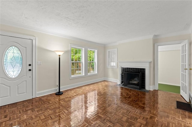 1098 Cascade Cir SW, Atlanta, GA 30311 - foyer entrance featuring baseboards, a fireplace, ornamental molding, and a textured ceiling