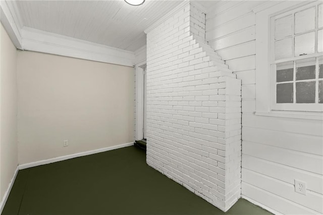 1098 Cascade Cir SW, Atlanta, GA 30311 - unfurnished room with crown molding, baseboards, and brick wall