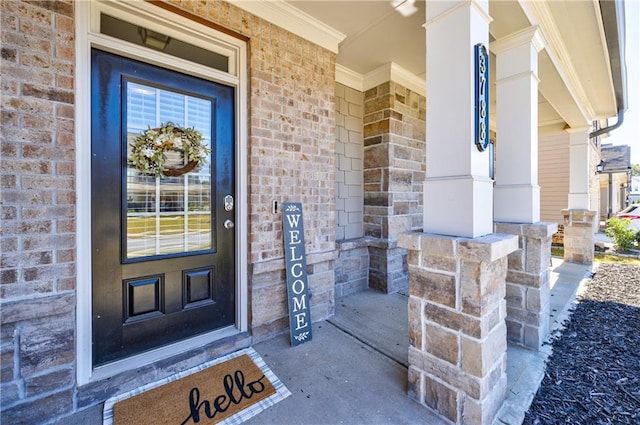 view of exterior entry featuring covered porch