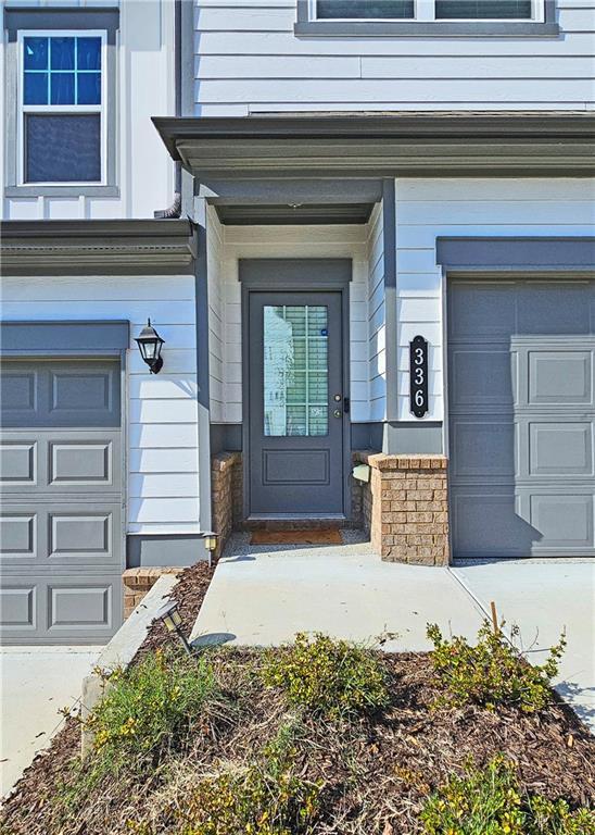 doorway to property with a garage