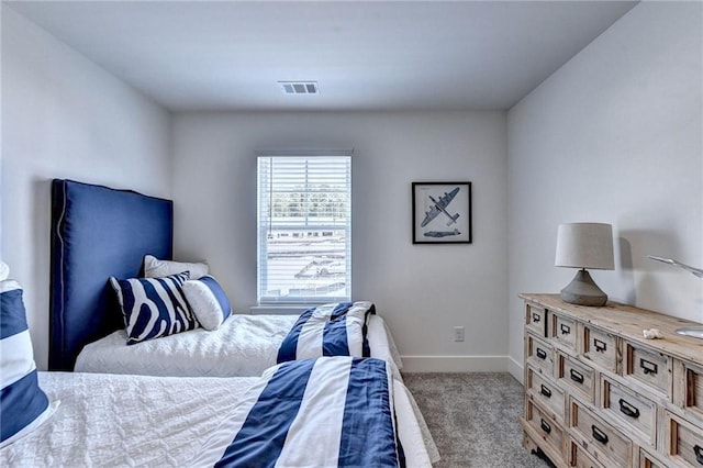 carpeted bedroom with visible vents and baseboards